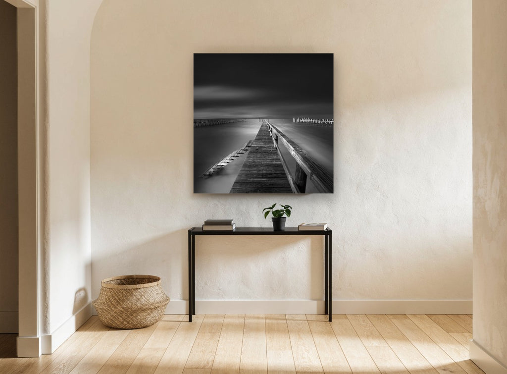 Silent Jetty Noir coastal canvas print on the wall of a hallway