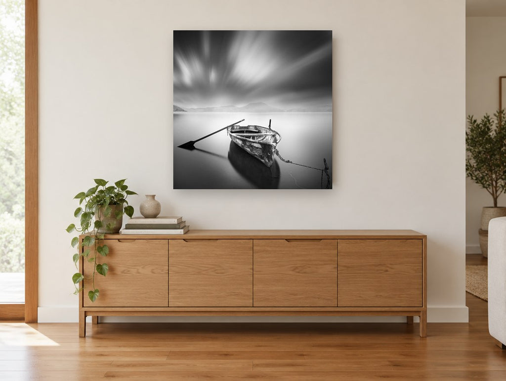 Moored Rowboat Stillness coastal canvas print on the wall of a living room above a sideboard