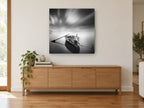Moored Rowboat Stillness coastal canvas print on the wall of a living room above a sideboard