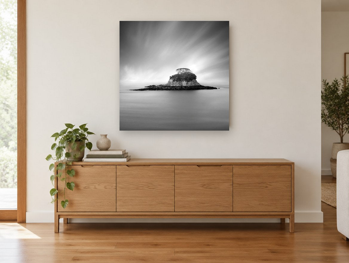 Silent Island coastal canvas print on the wall of a living room above a sideboard