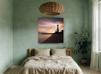 Lighthouse Dusk Glow coastal canvas print on the wall of a bedroom