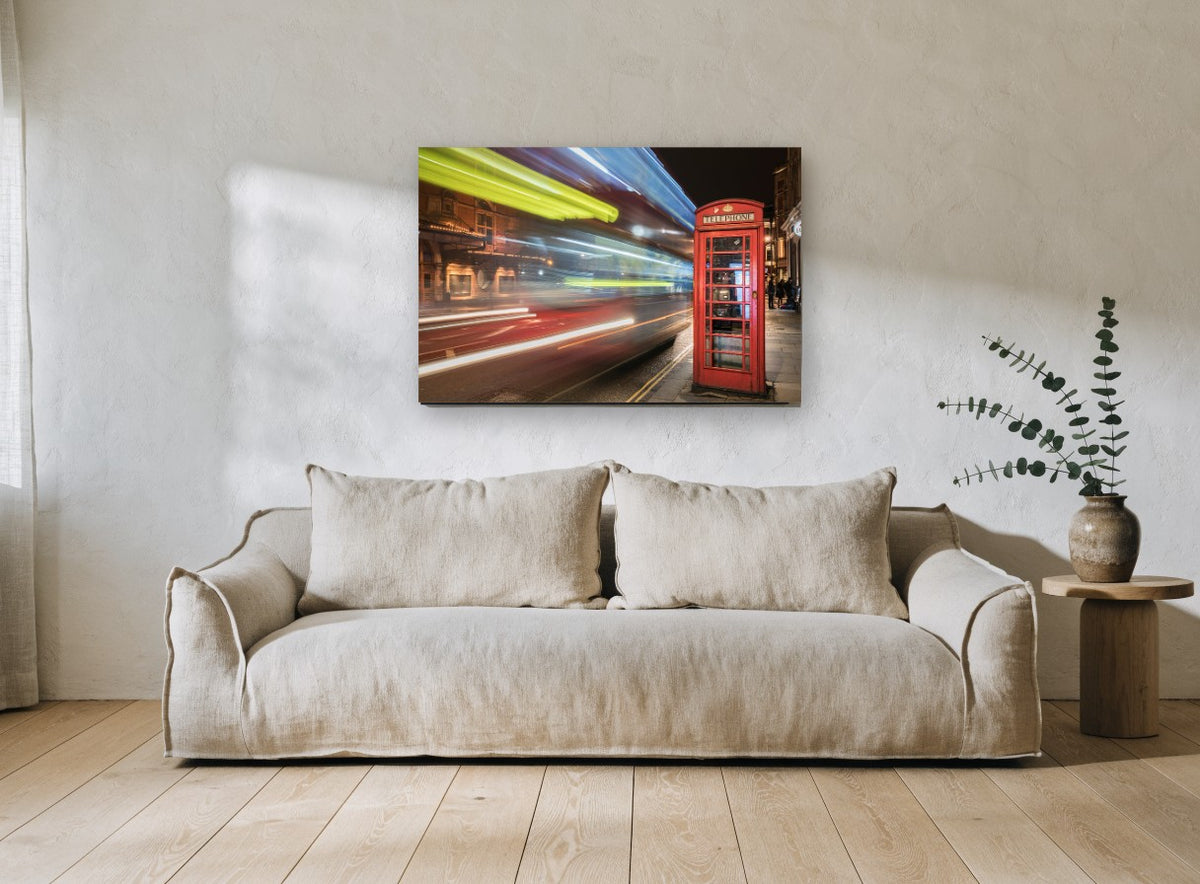 Red Box Night Blur city canvas print on the wall of a living room