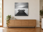 Still Water Jetty coastal canvas print on the wall of a living room above a sideboard