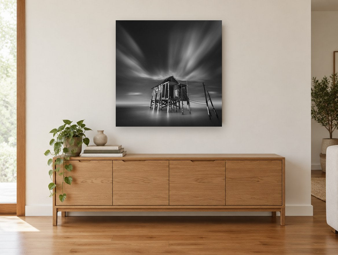 Stilted Shack Stillness coastal canvas print on the wall of a living room above a sideboard