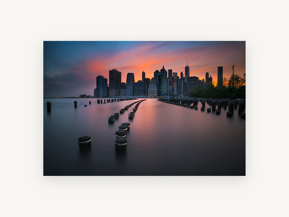 Pilings at Manhattan Dusk, manhattan skyline sunset over pilings, city canvas wall art print, front view