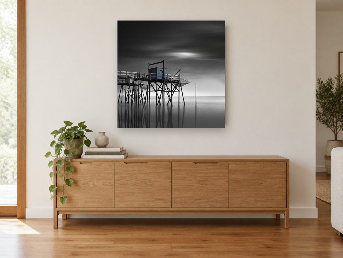 Blue Fishing Hut Stilts coastal canvas print on the wall of a living room above a sideboard