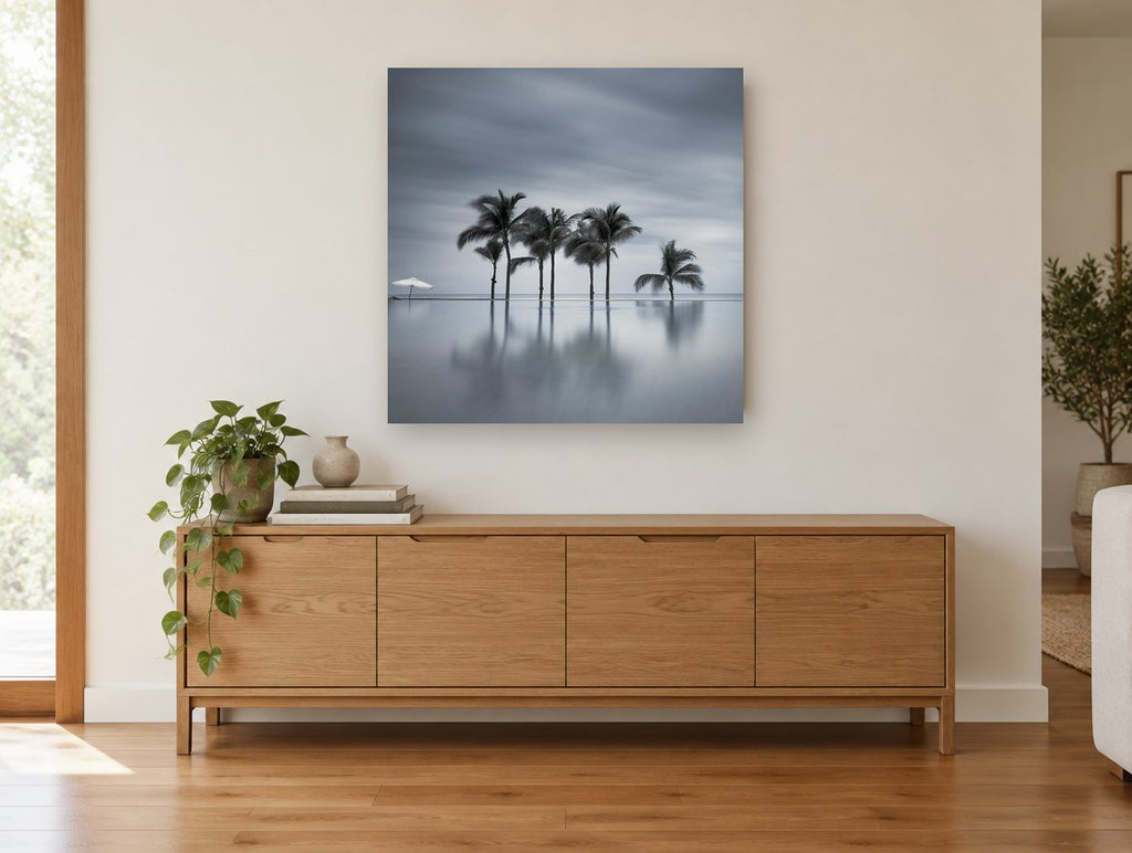 Still Water Palms coastal canvas print on the wall of a living room above a sideboard