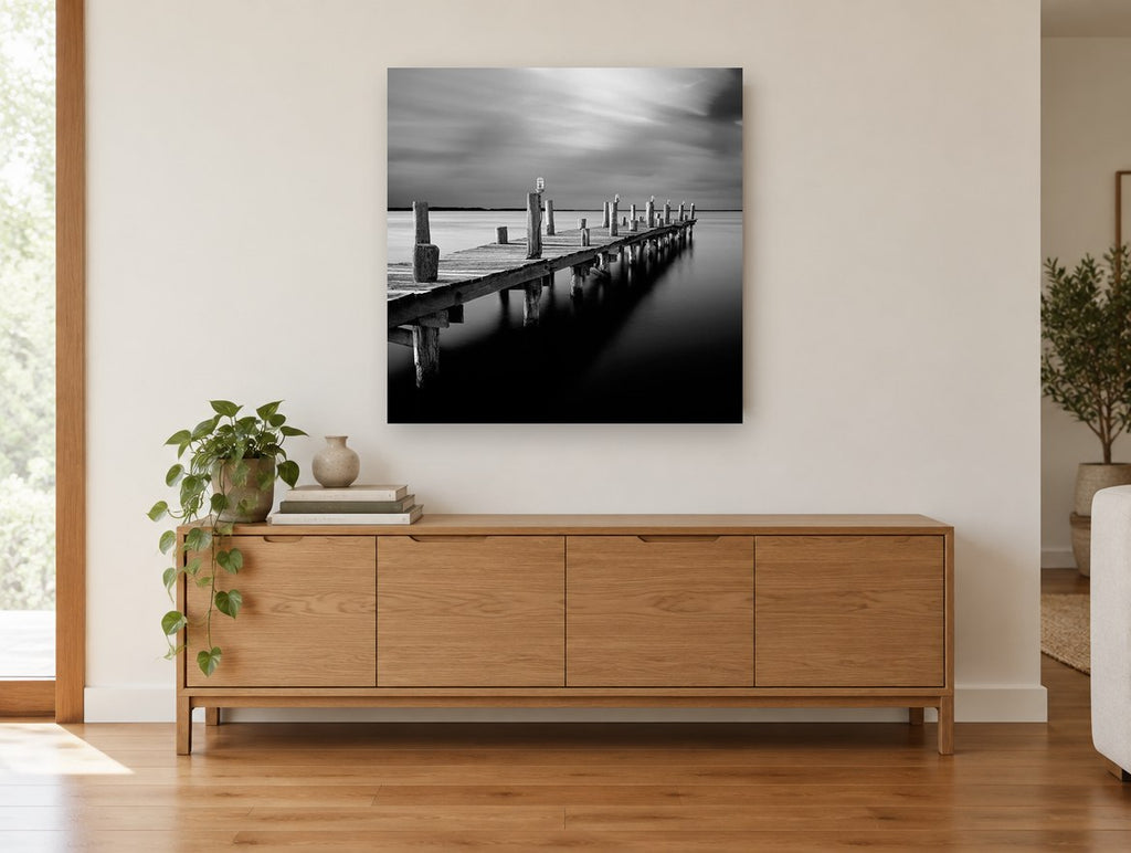Silent Jetty Dusk coastal canvas print on the wall of a living room above a sideboard