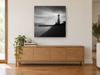 Beacon on the Shore coastal canvas print on the wall of a living room above a sideboard