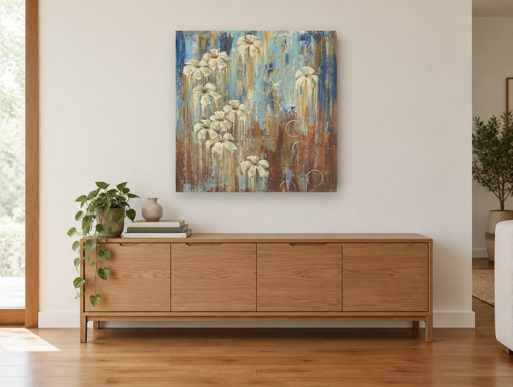 Cream Blooms in Rust Rain floral canvas print on the wall of a living room above a sideboard