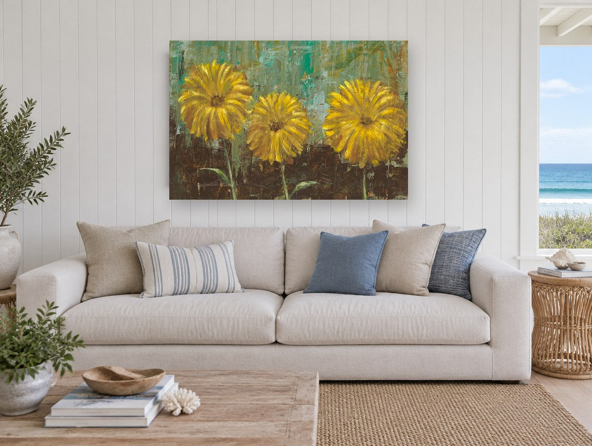 Three Golden Blooms floral canvas print on the wall of a beach house living room
