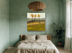 Three Amber Trees floral canvas print on the wall of a bedroom