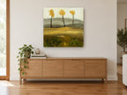 Three Golden Trees floral canvas print on the wall of a living room above a sideboard
