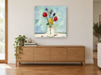 Bright Blooms in Glass floral canvas print on the wall of a living room above a sideboard