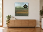 Lone Tree Green Field floral canvas print on the wall of a living room above a sideboard