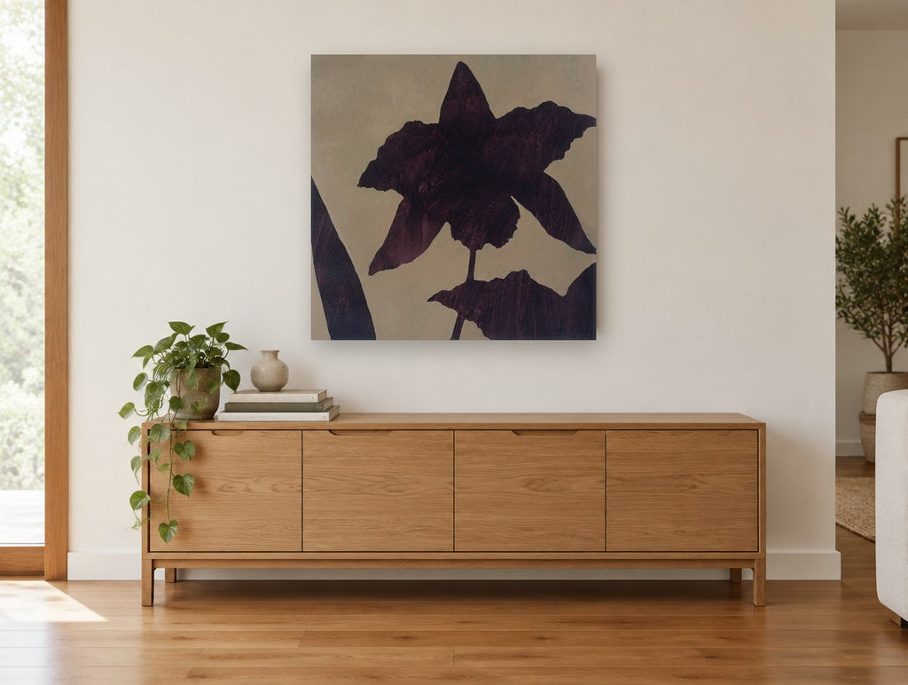 Aubergine Orchid Silhouette floral canvas print on the wall of a living room above a sideboard
