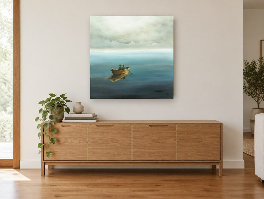 Two in a Rowboat coastal canvas print on the wall of a living room above a sideboard