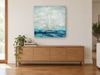 Sails in Soft Blue coastal canvas print on the wall of a living room above a sideboard