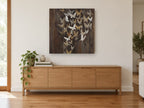 Gilded Butterfly Flurry floral canvas print on the wall of a living room above a sideboard
