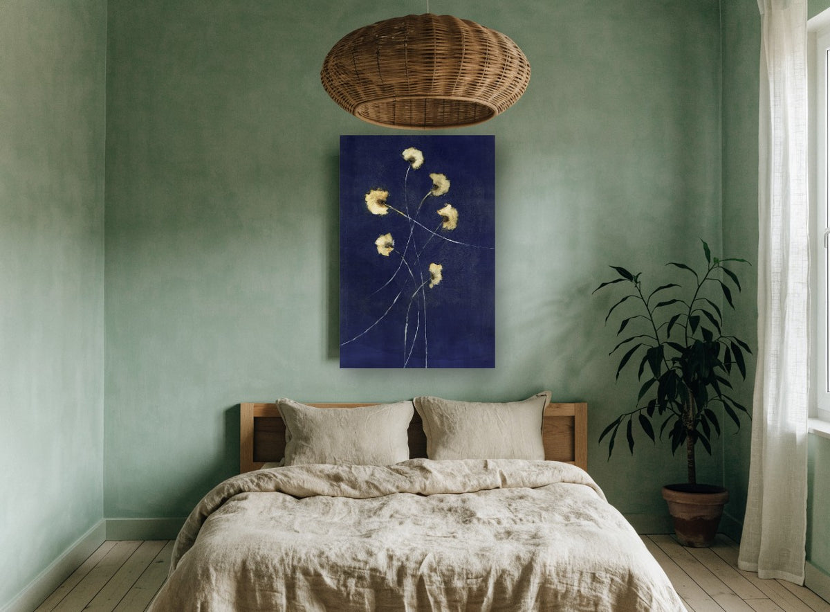 Gold Blooms on Indigo floral canvas print on the wall of a bedroom