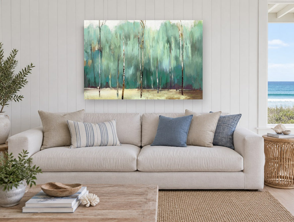 Teal Birch Grove floral canvas print on the wall of a beach house living room