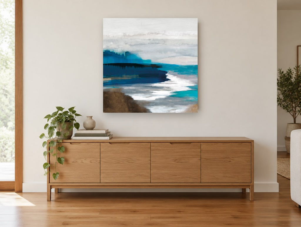Indigo Shore Drift coastal canvas print on the wall of a living room above a sideboard