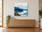 Indigo Shore Drift coastal canvas print on the wall of a living room above a sideboard