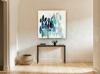 Teal Leaf Drift floral canvas print on the wall of a hallway