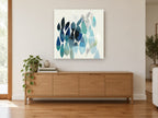 Teal Leaf Drift floral canvas print on the wall of a living room above a sideboard
