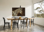 Zebra in Dark Amber animal canvas print on the wall of a dining room