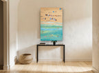 Sand and Swimmers Above coastal canvas print on the wall of a hallway