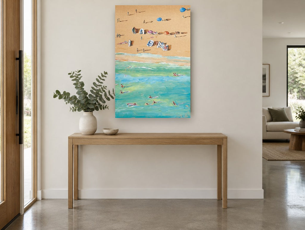 Sand and Swimmers Above coastal canvas print on the wall of a entry hall
