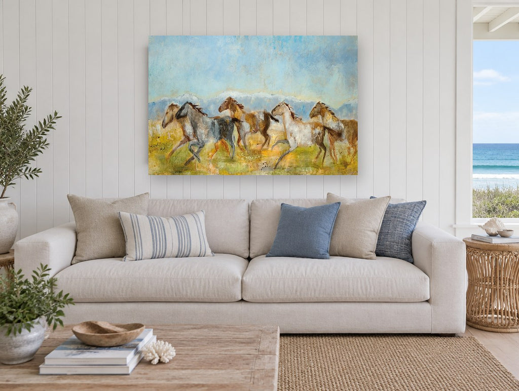 Galloping Mountain Herd animal canvas print on the wall of a beach house living room