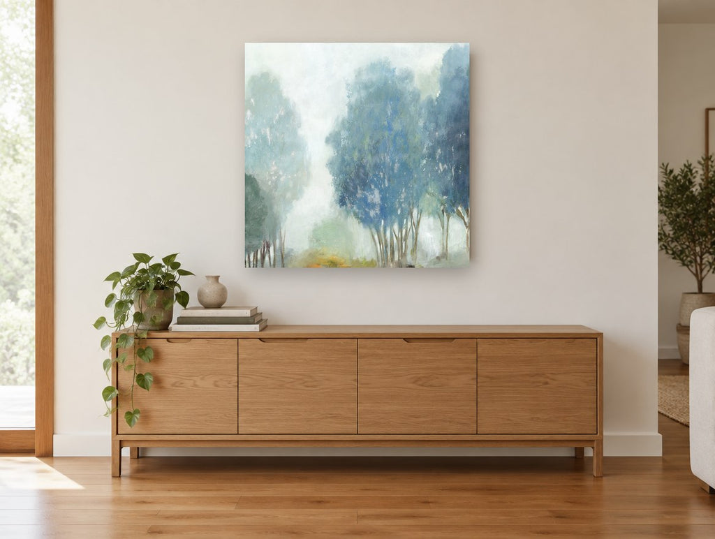 Blue Mist Grove floral canvas print on the wall of a living room above a sideboard