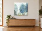 Blue Mist Grove floral canvas print on the wall of a living room above a sideboard
