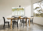 Dappled Canopy Row floral canvas print on the wall of a dining room