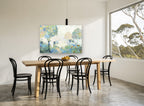 Misty Orchard Light floral canvas print on the wall of a dining room