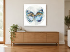 Indigo Moon Butterfly floral canvas print on the wall of a living room above a sideboard