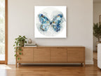 Indigo Wing Circle floral canvas print on the wall of a living room above a sideboard
