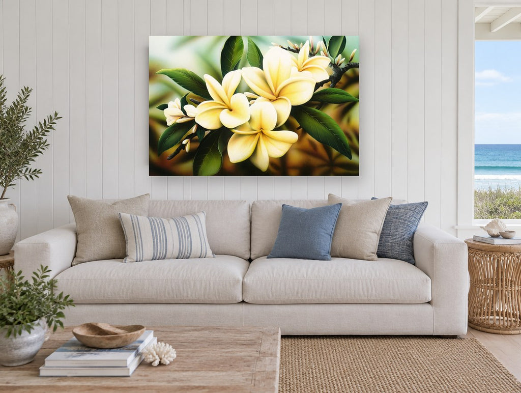 Golden Frangipani Branch floral canvas print on the wall of a beach house living room