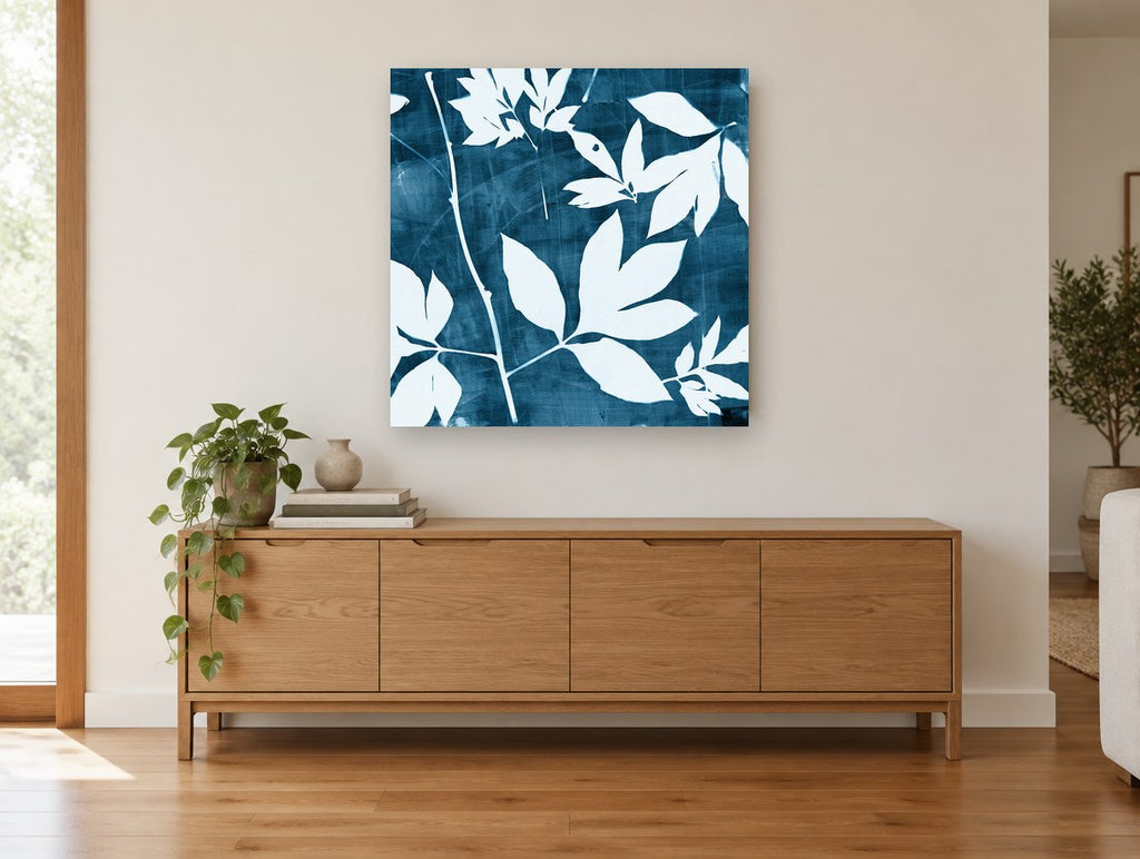 Indigo Leaf Silhouettes floral canvas print on the wall of a living room above a sideboard