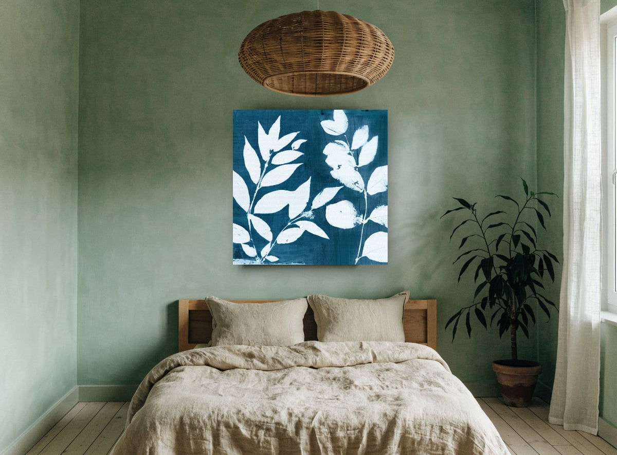 Indigo Leaf Silhouettes floral canvas print on the wall of a bedroom