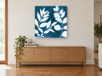 Indigo Leaf Silhouettes floral canvas print on the wall of a living room above a sideboard