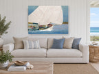 Sails Full Across Blue coastal canvas print on the wall of a beach house living room