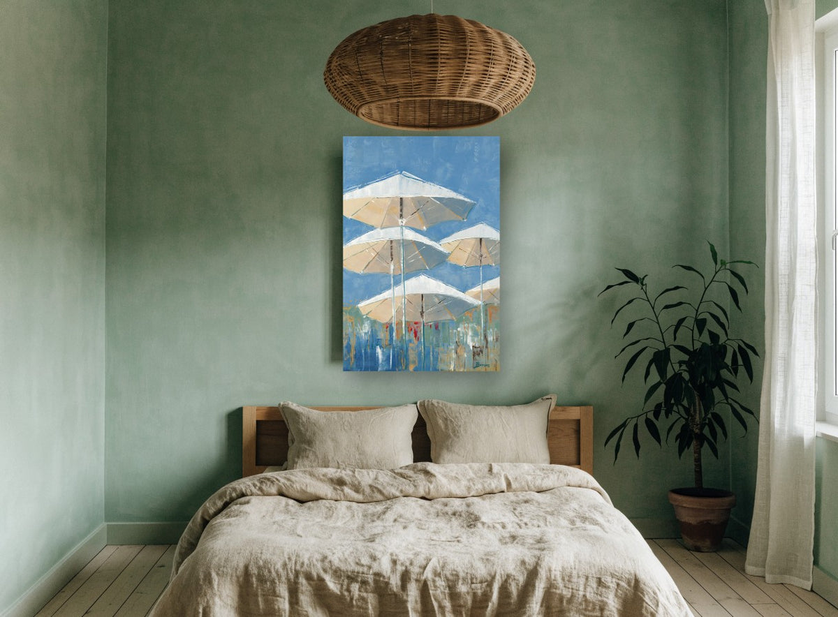 Parasols Against Blue coastal canvas print on the wall of a bedroom
