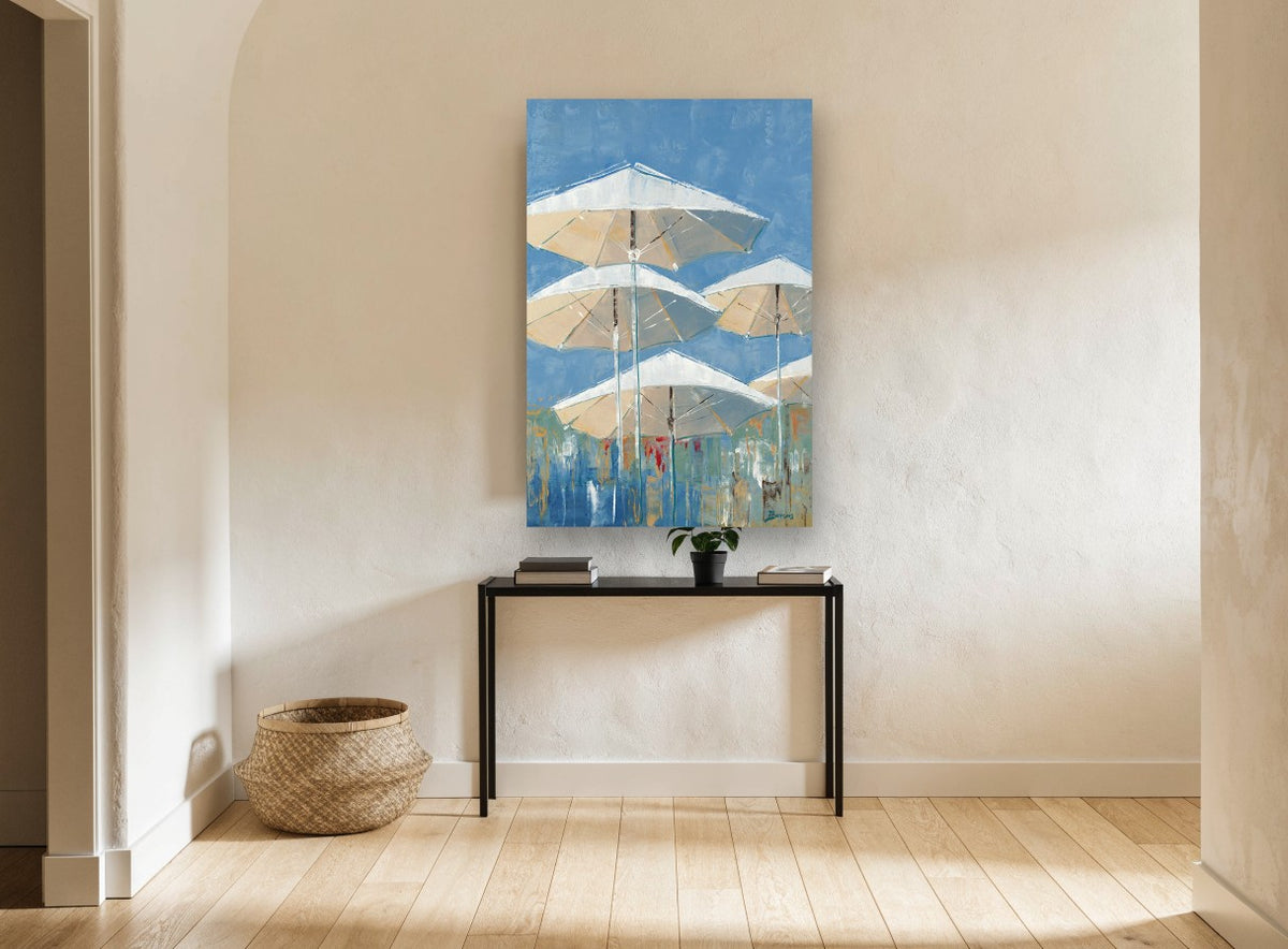 Parasols Against Blue coastal canvas print on the wall of a hallway