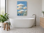 Parasols Against Blue coastal canvas print on the wall of a bathroom