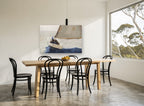Single Sail Heeling coastal canvas print on the wall of a dining room