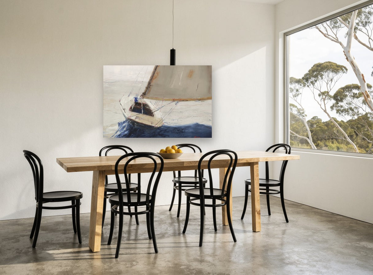 Single Sail Heeling coastal canvas print on the wall of a dining room