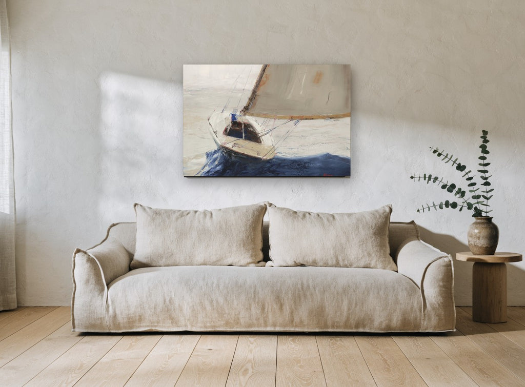 Single Sail Heeling coastal canvas print on the wall of a living room